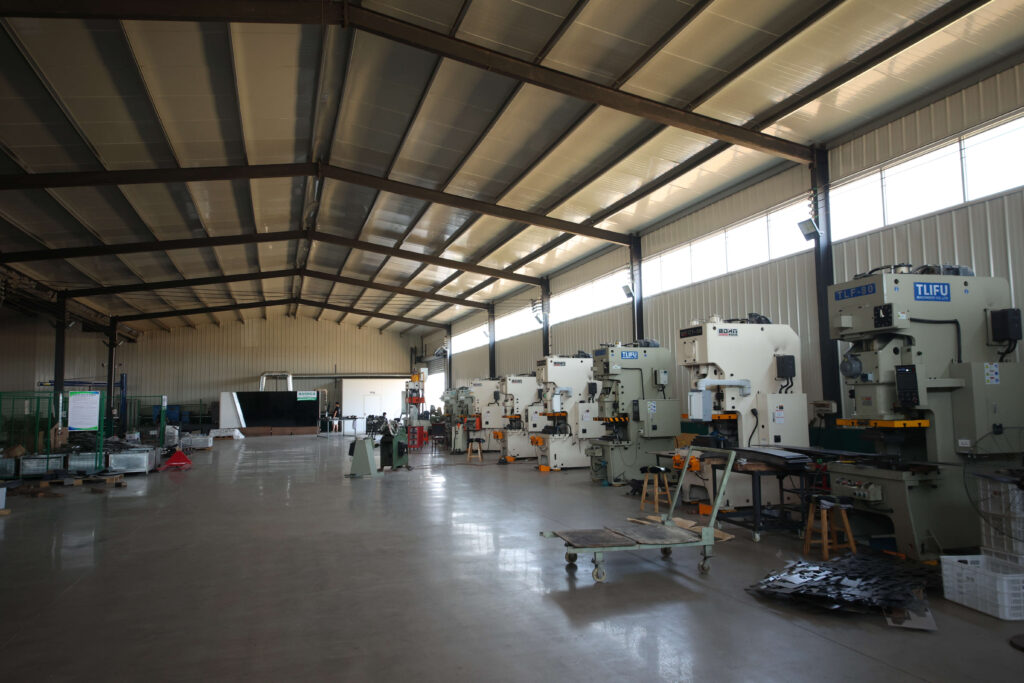 The production floor at the Nanpi factory, with stamping presses lined up along the aisle