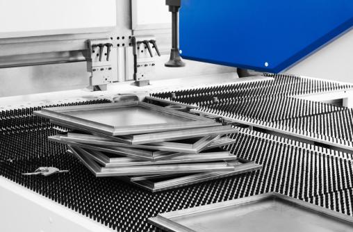 Press-braked sheet metal parts on a work table after forming